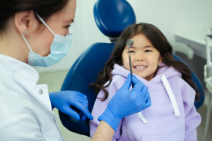 a dentist showing a dental tool to a patient