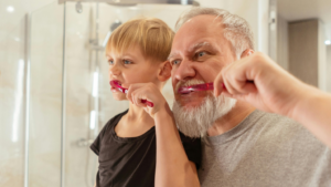 a man and young boy brushing their teeth