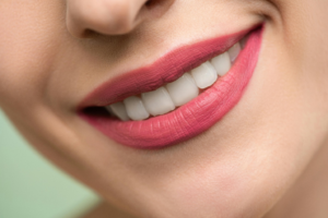 a woman’s smile with light red lipstick