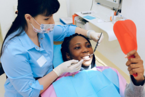 A dentist checking a patient’s teeth