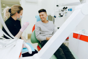 An image of a man smiling while sitting on a dental chair1